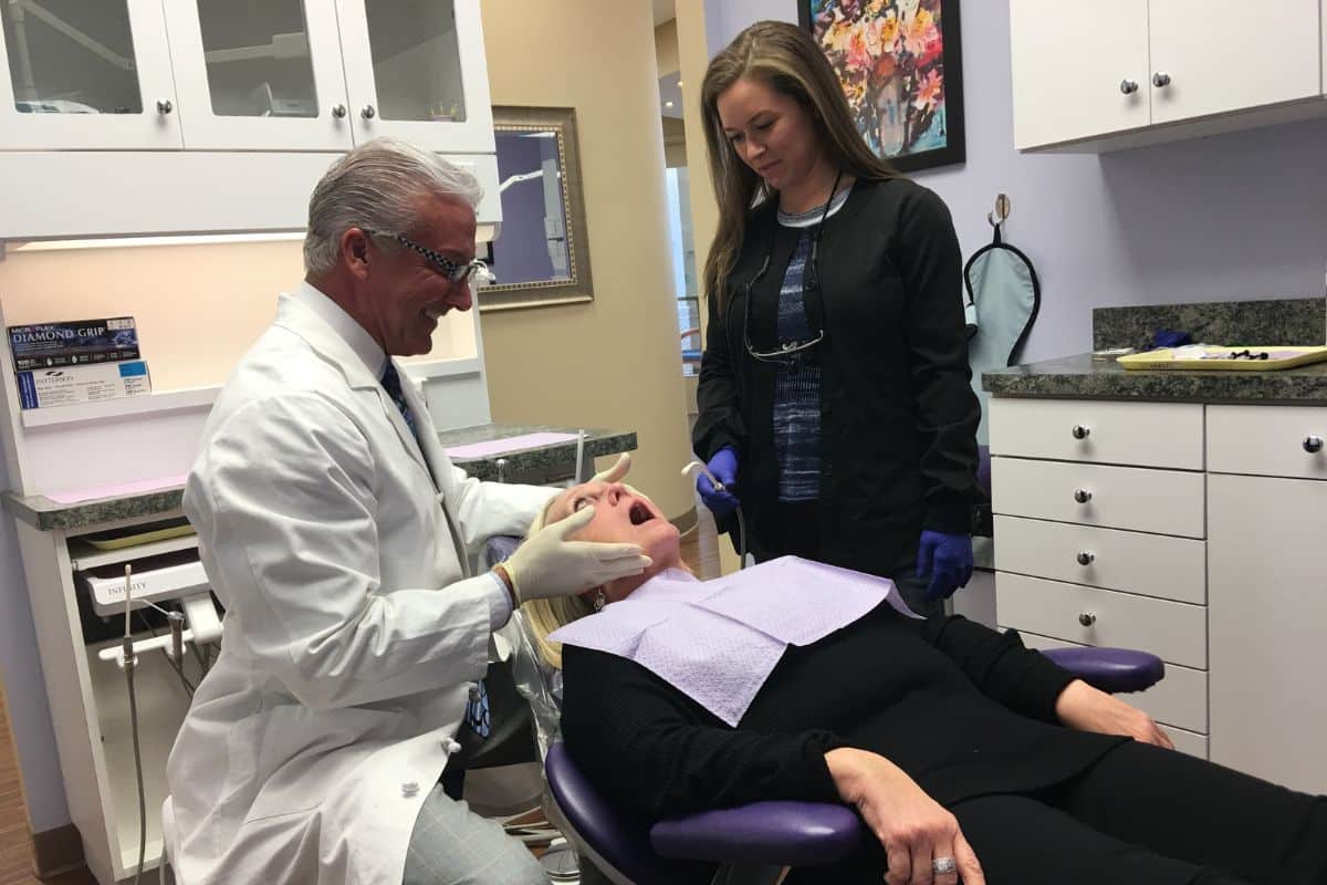 Dentist performing a teeth cleaning at gentle dental center
